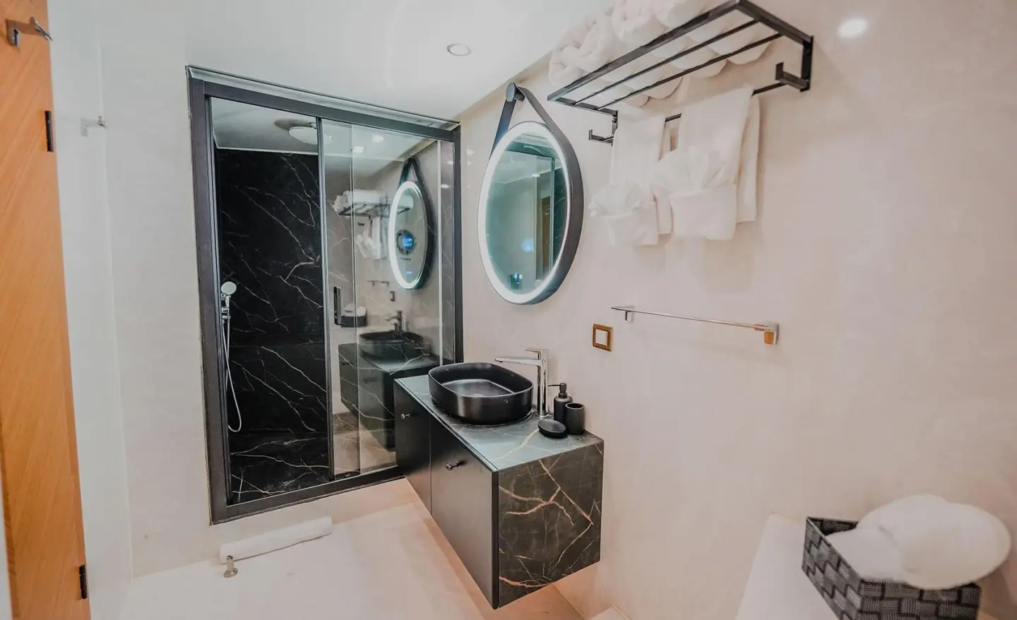 Compact yacht bathroom with sink, mirror, and porthole on King Of The Sea