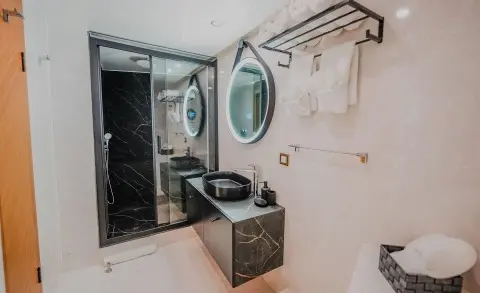 Compact yacht bathroom with sink, mirror, and porthole on King Of The Sea