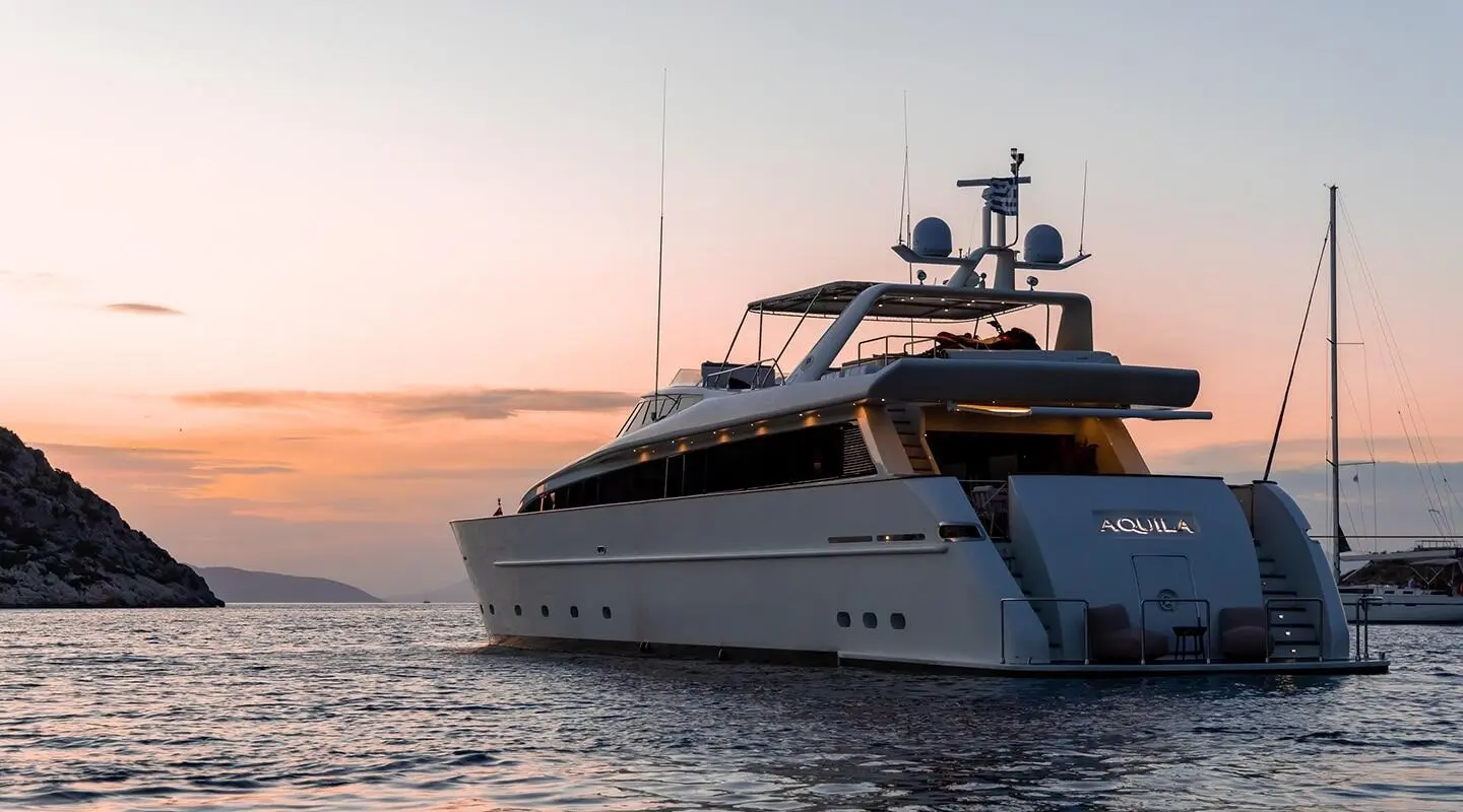 Aquila motor yacht at sunset photographed from the water