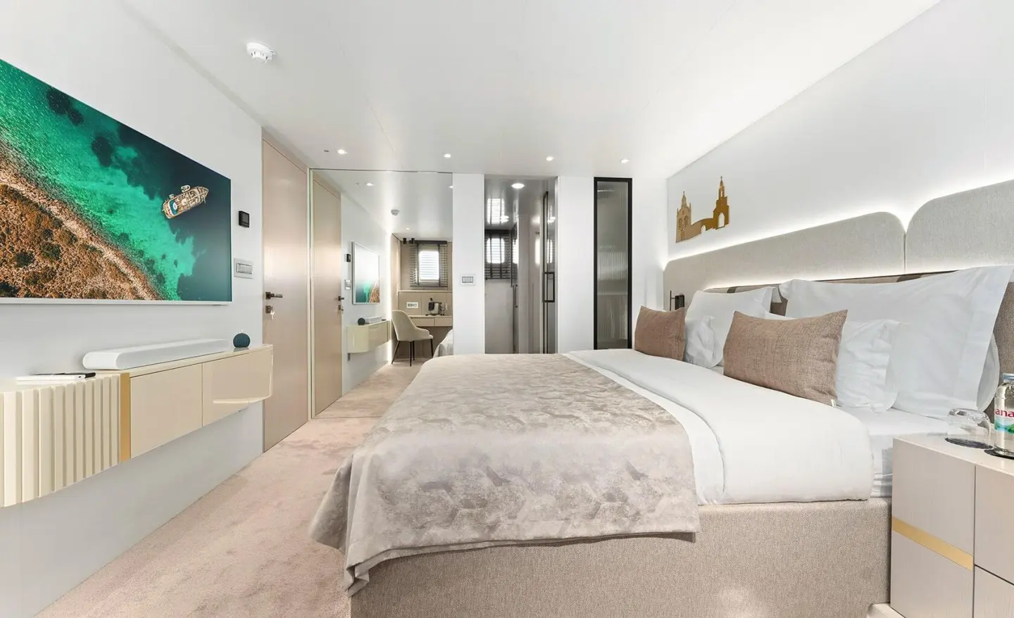 Maxita luxury yacht bedroom with large bed, neutral tones, and seating area