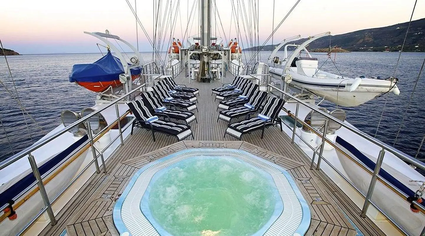 Top-down view of a luxury yacht deck with pool, sun loungers and seating around