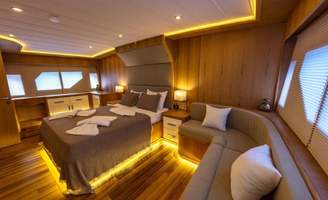 Interior of Simay M yacht master cabin with bedside storage and seating