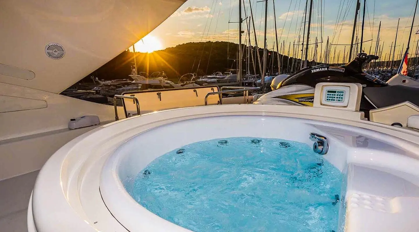 Miss Katariina yacht deck with jacuzzi and sun loungers at sunset
