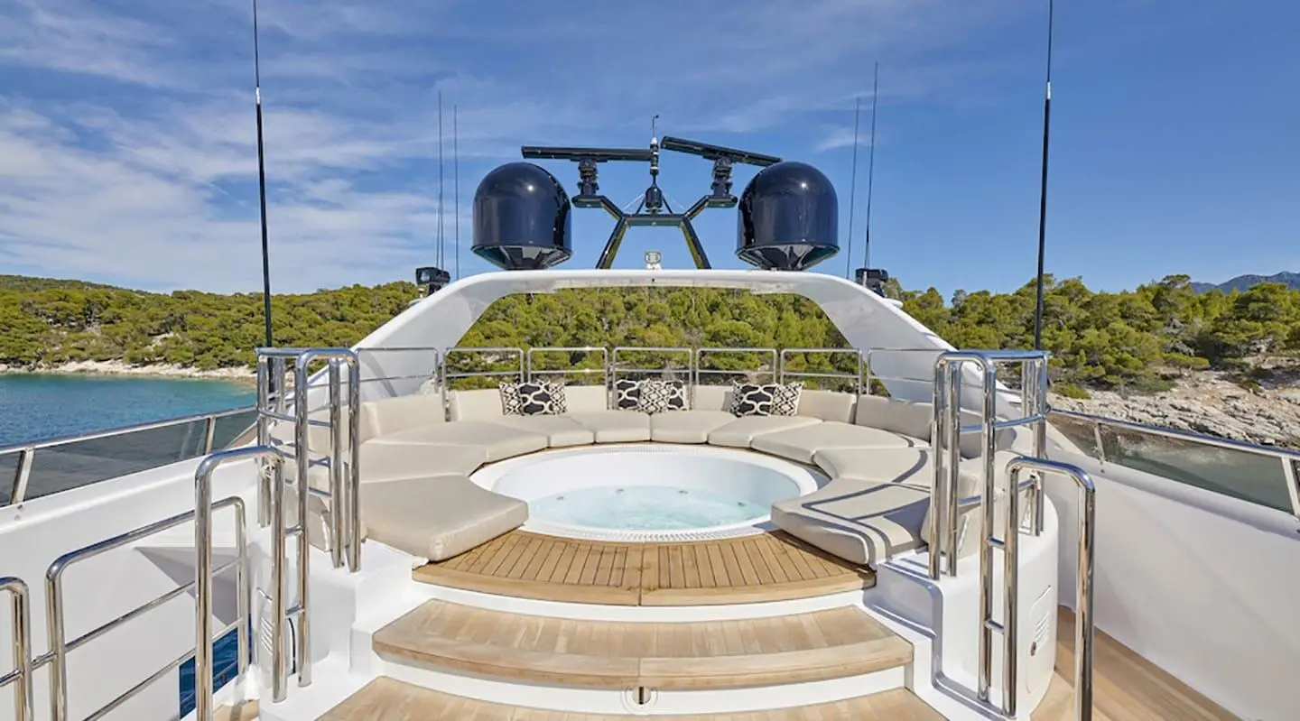 Daloli yacht stern deck with jacuzzi and seating on aft platform, sunny day