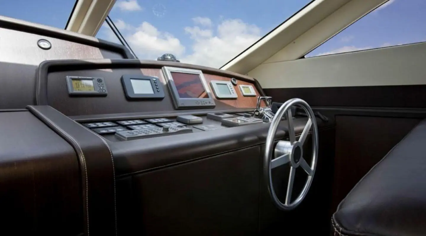 Miraval yacht cockpit with polished dark wood, steering wheel, and dashboard