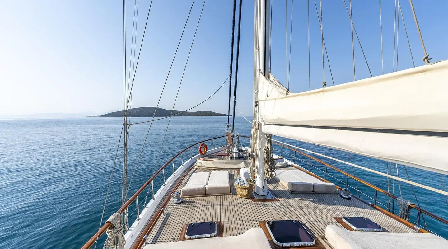 Artemis luxury gulet sailing at sunset with deck and rigging on calm sea