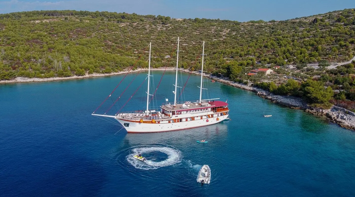 Amorena motor yacht seen from above, red and white vessel anchored in blue water