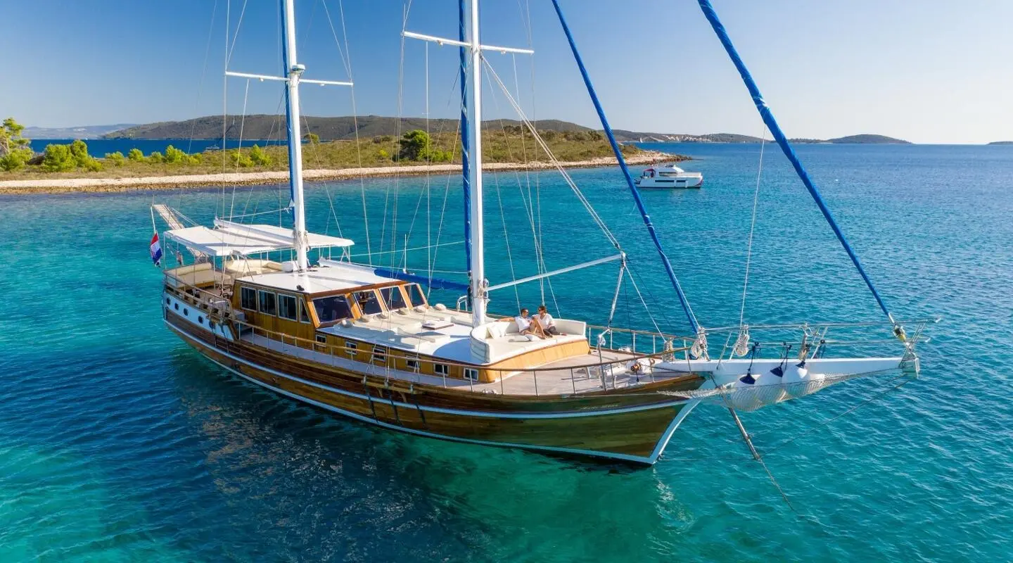 Gulet Andi Star anchored in blue sea with deck and rigging visible