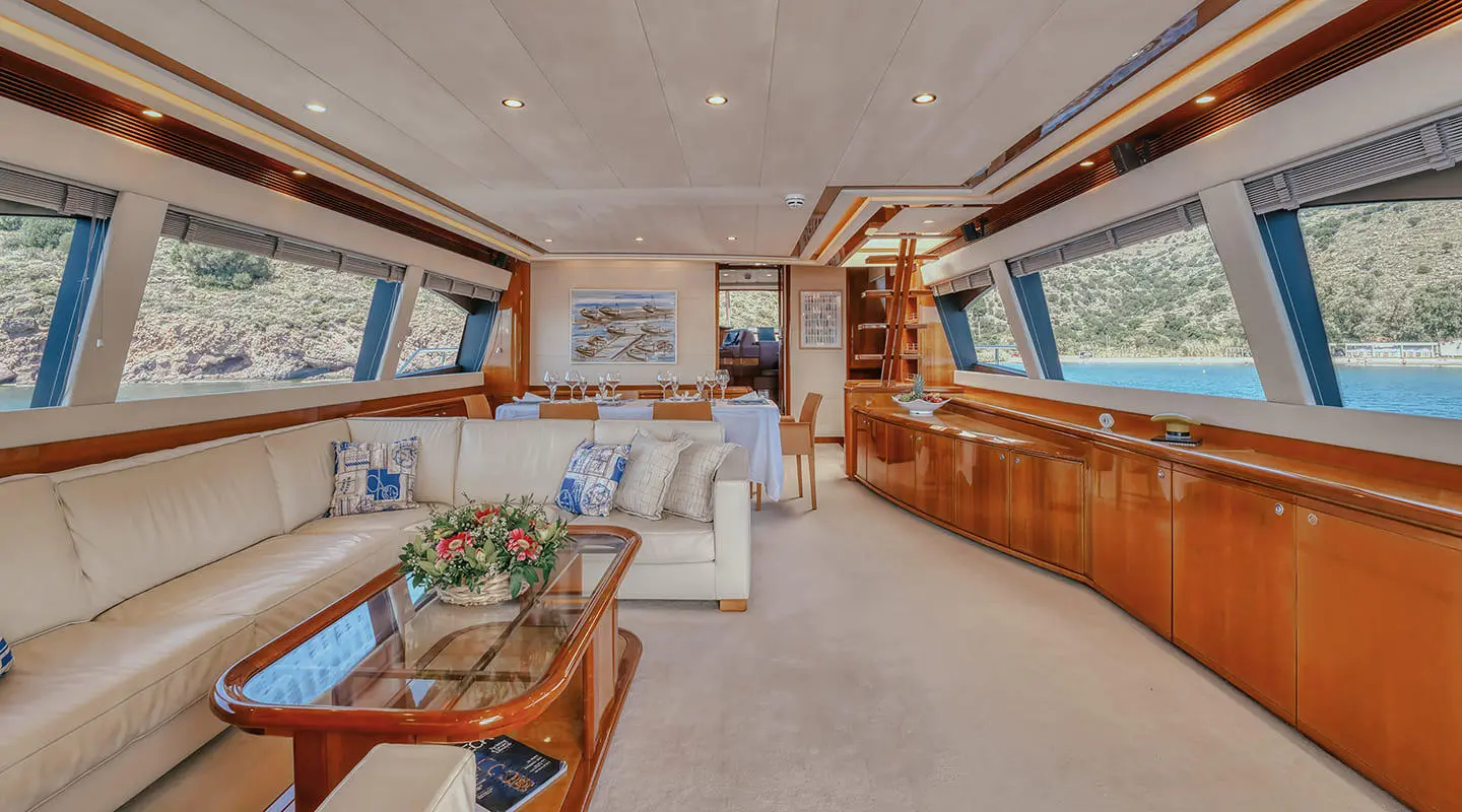 Luxurious yacht Lidia interior: spacious salon with seating, wood paneling, and large windows