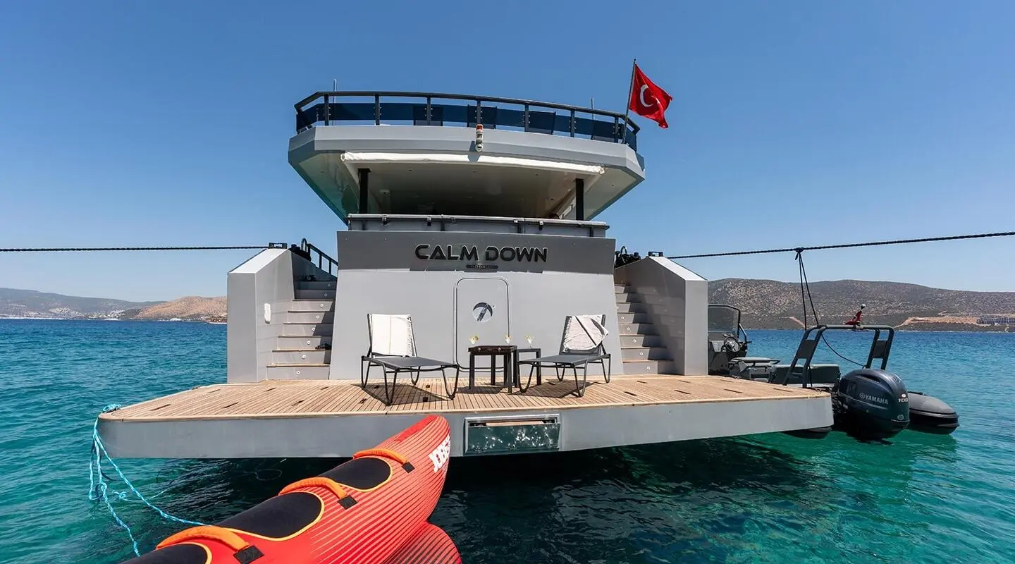 Split level luxury yacht Calm Down on calm water with red life ring nearby