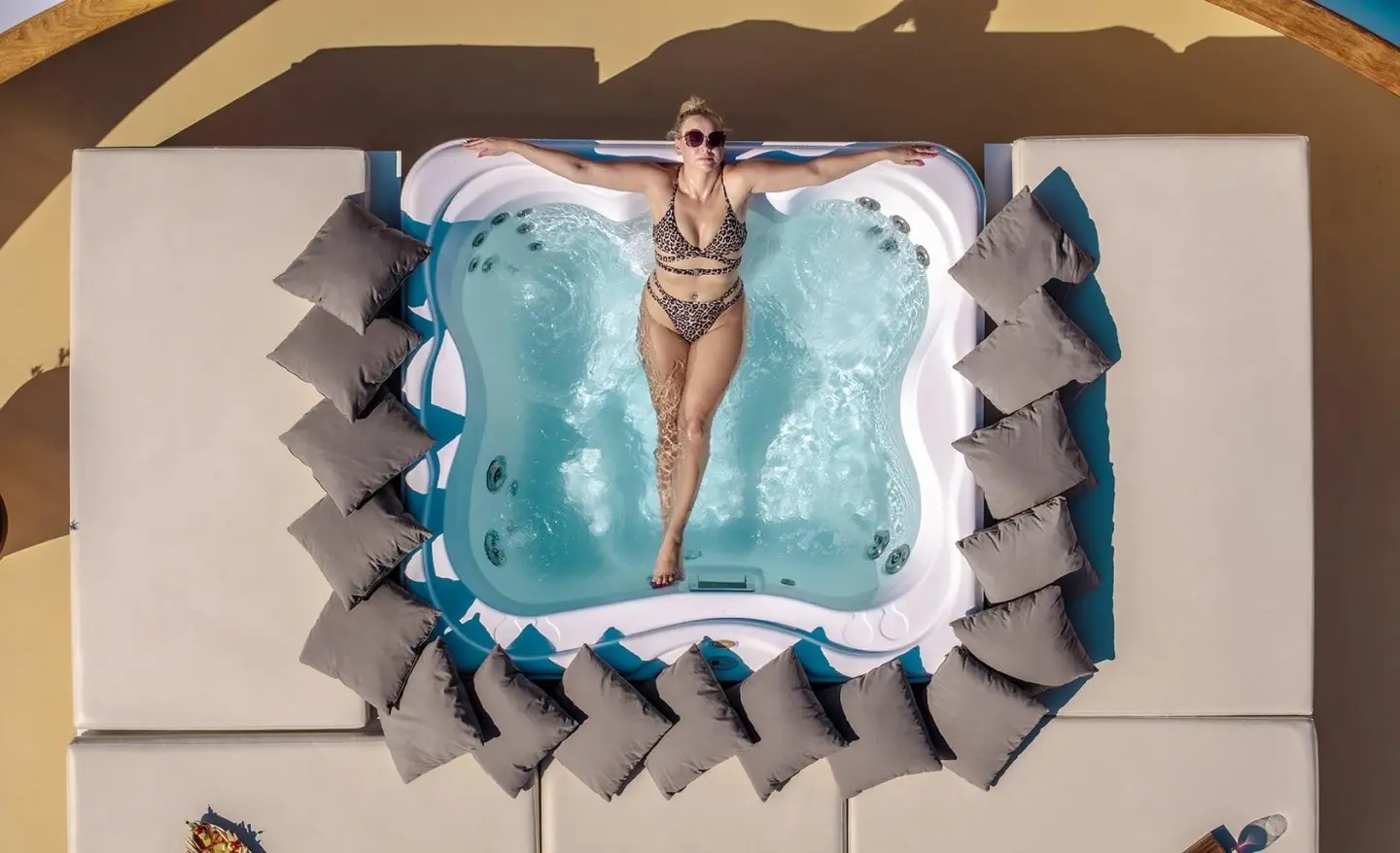 Top-down view of a luxury yacht Karizma with a hot tub surrounded by loungers