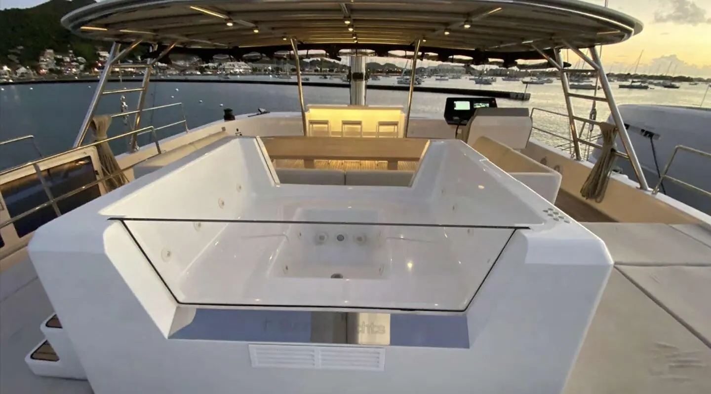 Above & Beyond yacht deck with sun loungers and seating at sunset