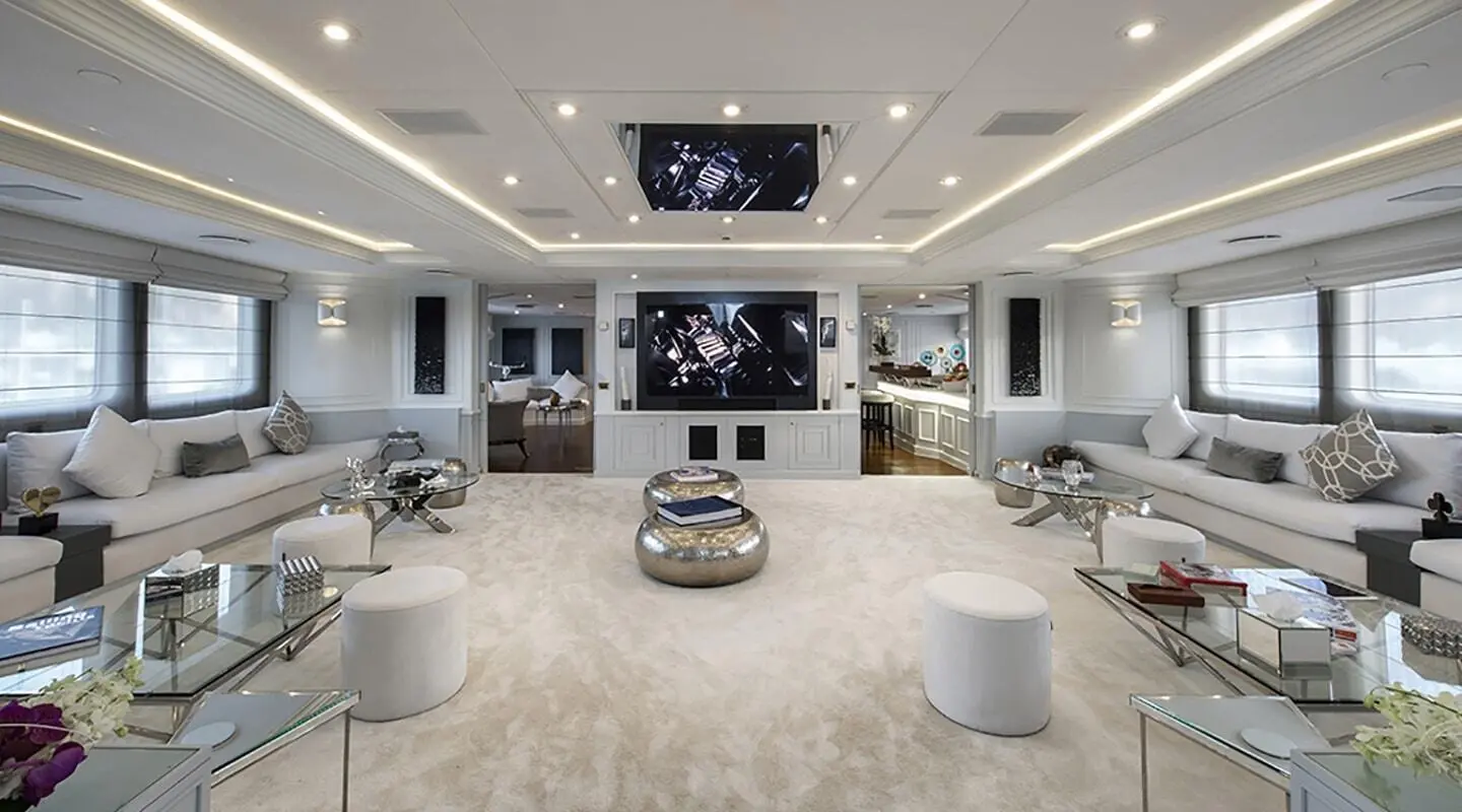Chakra luxury yacht salon at sunset with large windows and seating area