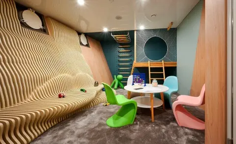 Interior of luxury yacht Ohana playroom with colorful seating and toys