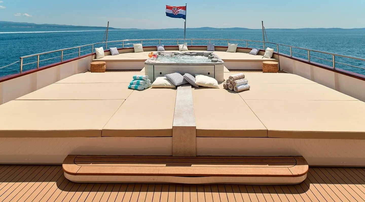 Ohana yacht deck view with sun loungers and sea horizon in daylight
