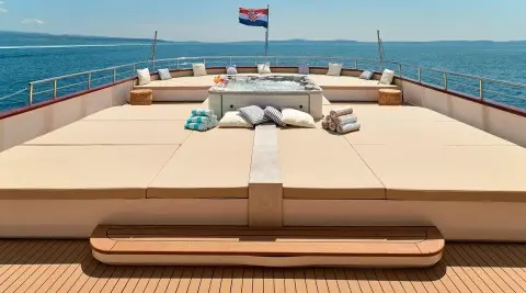 Ohana yacht deck view with sun loungers and sea horizon in daylight