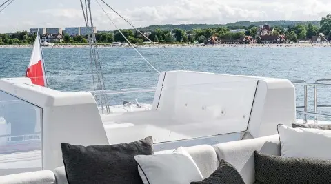 Yacht Above & Beyond flybridge with white seating and railing structure