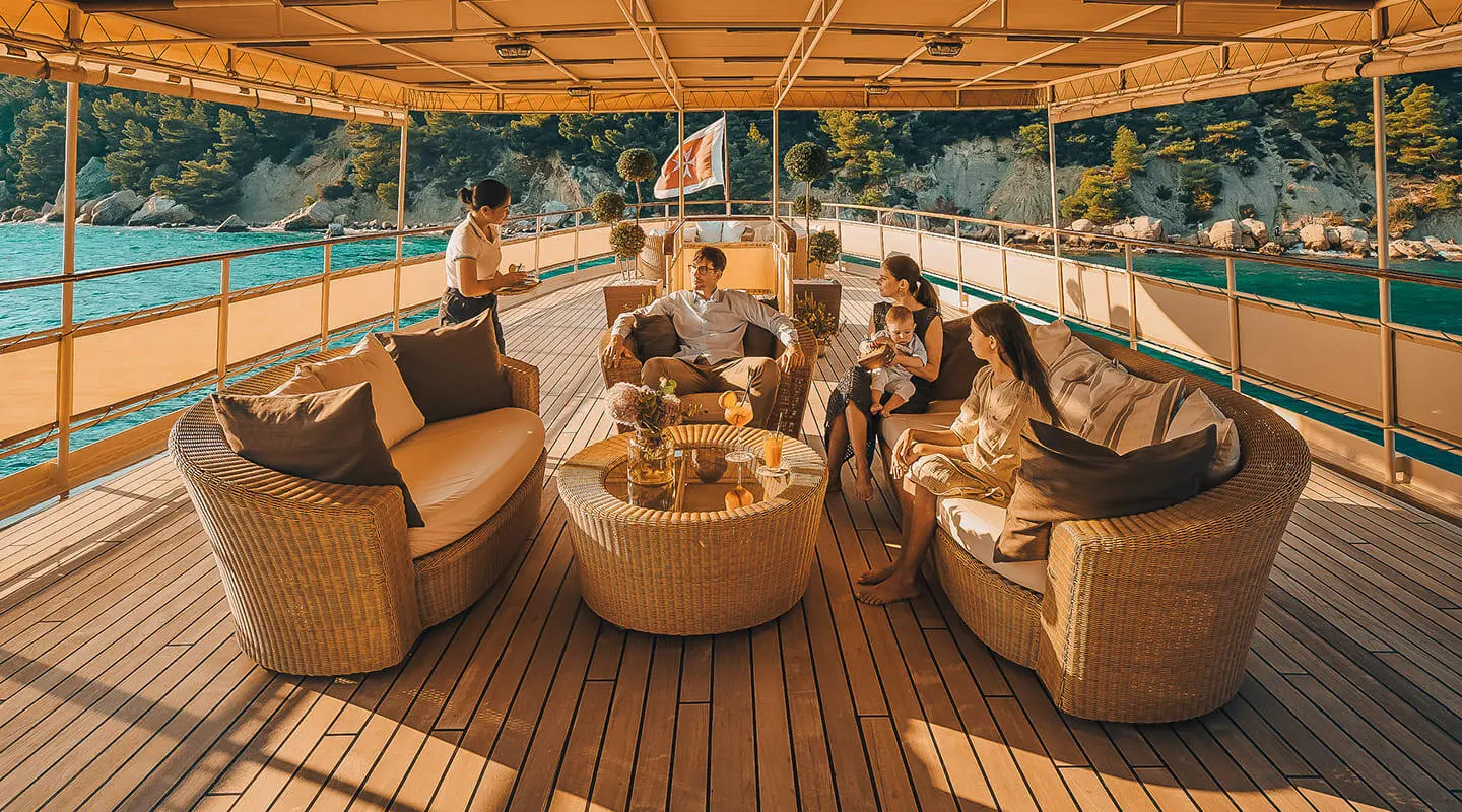 Seagull II yacht deck at sunset with seating area and people aboard