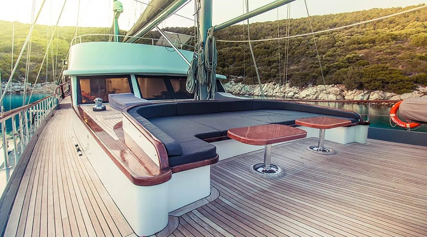 Deck seating area on Virtuoso luxury gulet with cushioned benches and sunpads