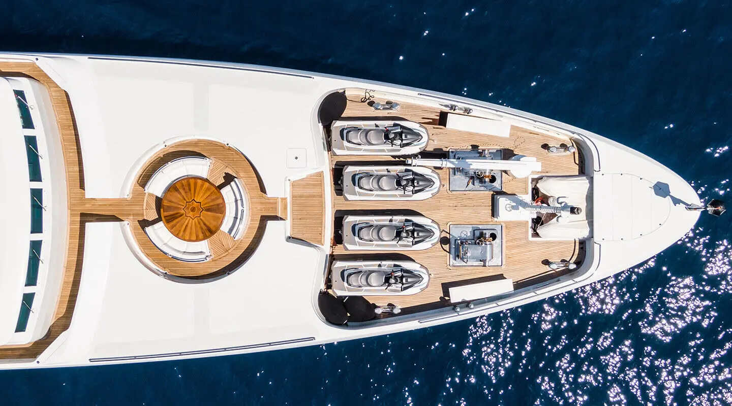 Top-down view of Apogee yacht with lifeboats along the deck and water surrounding