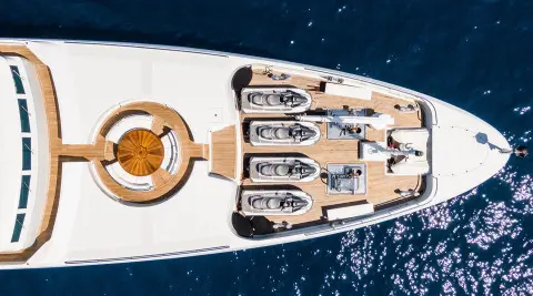 Top-down view of Apogee yacht with lifeboats along the deck and water surrounding