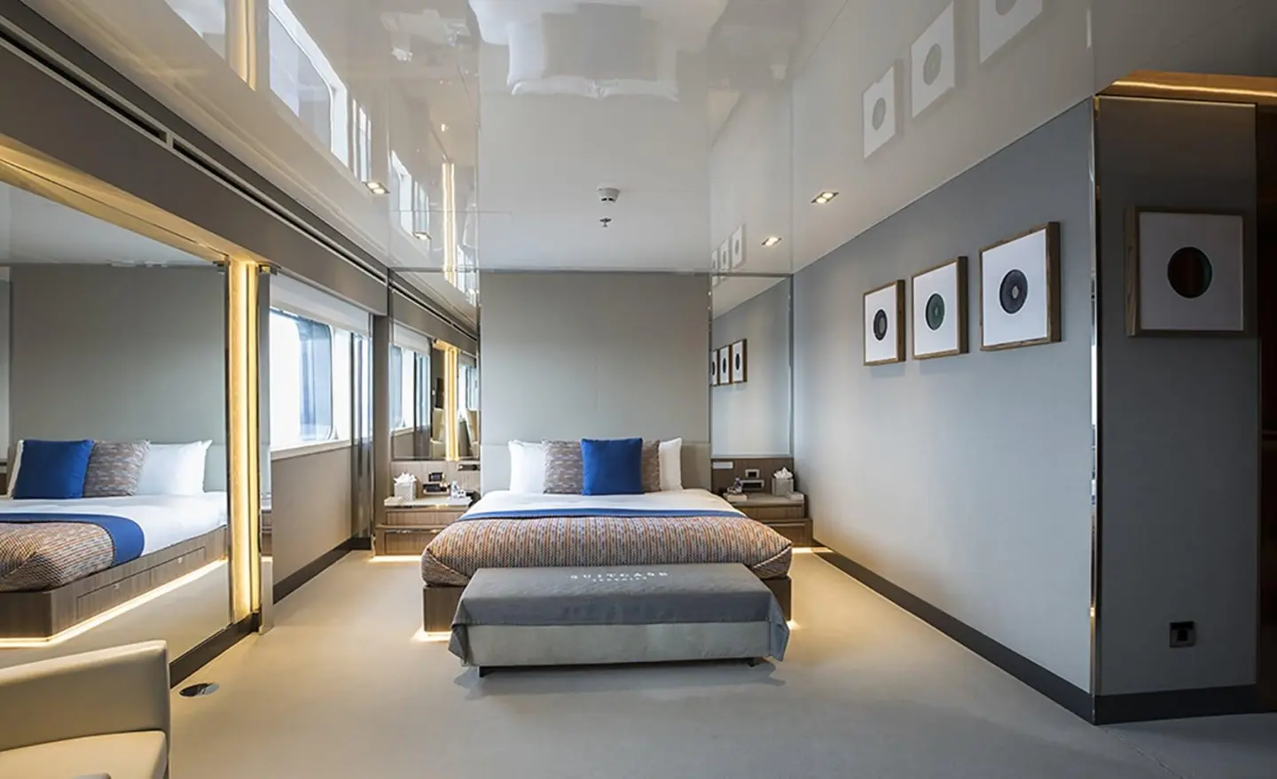 Spacious marquise yacht interior with a large bed, seating, and decorative pillows