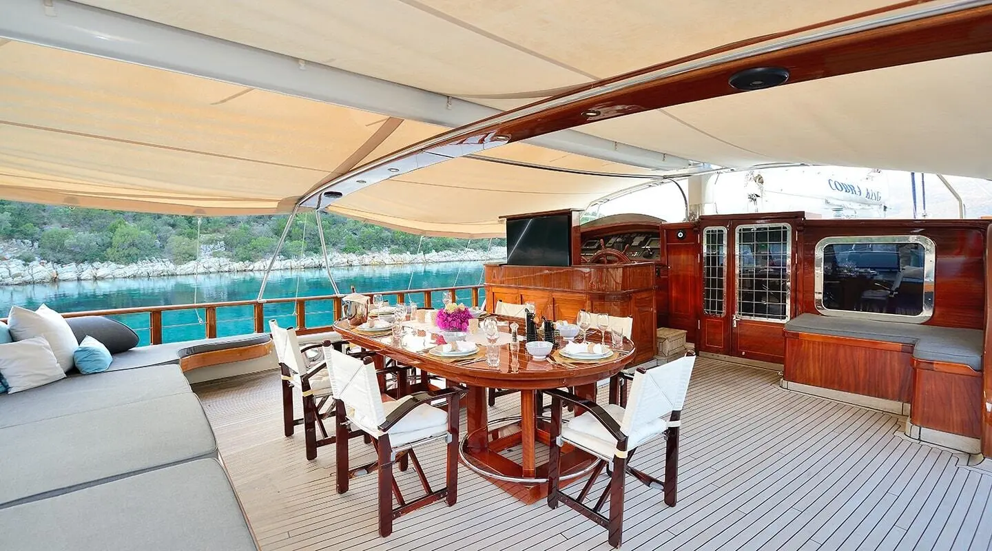 Cobra King gulet aft deck with dining table and chairs
