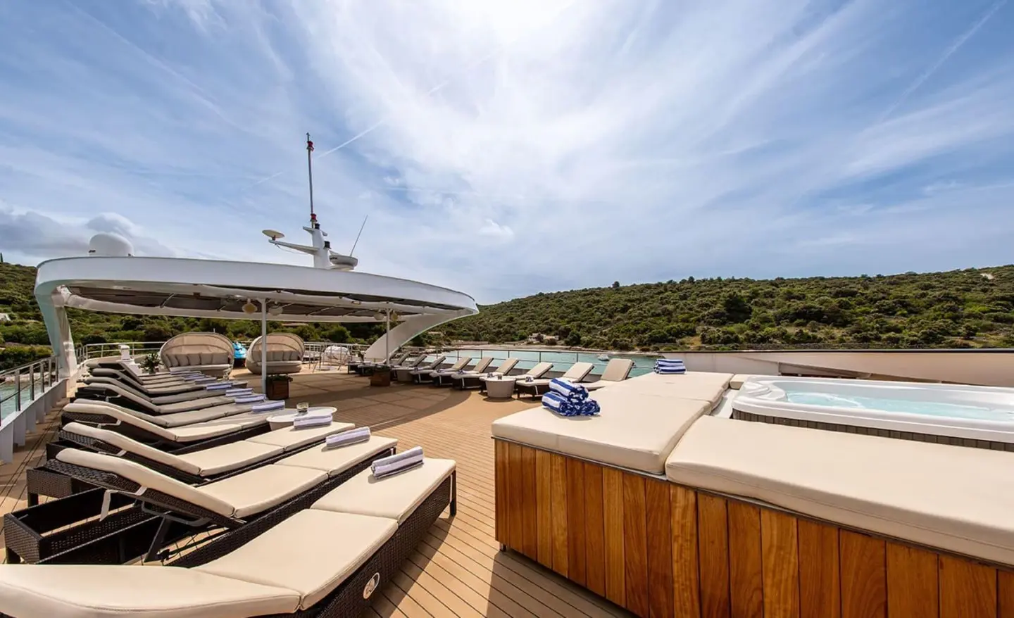 Karizma yacht sun deck with cushioned seating and lounging area