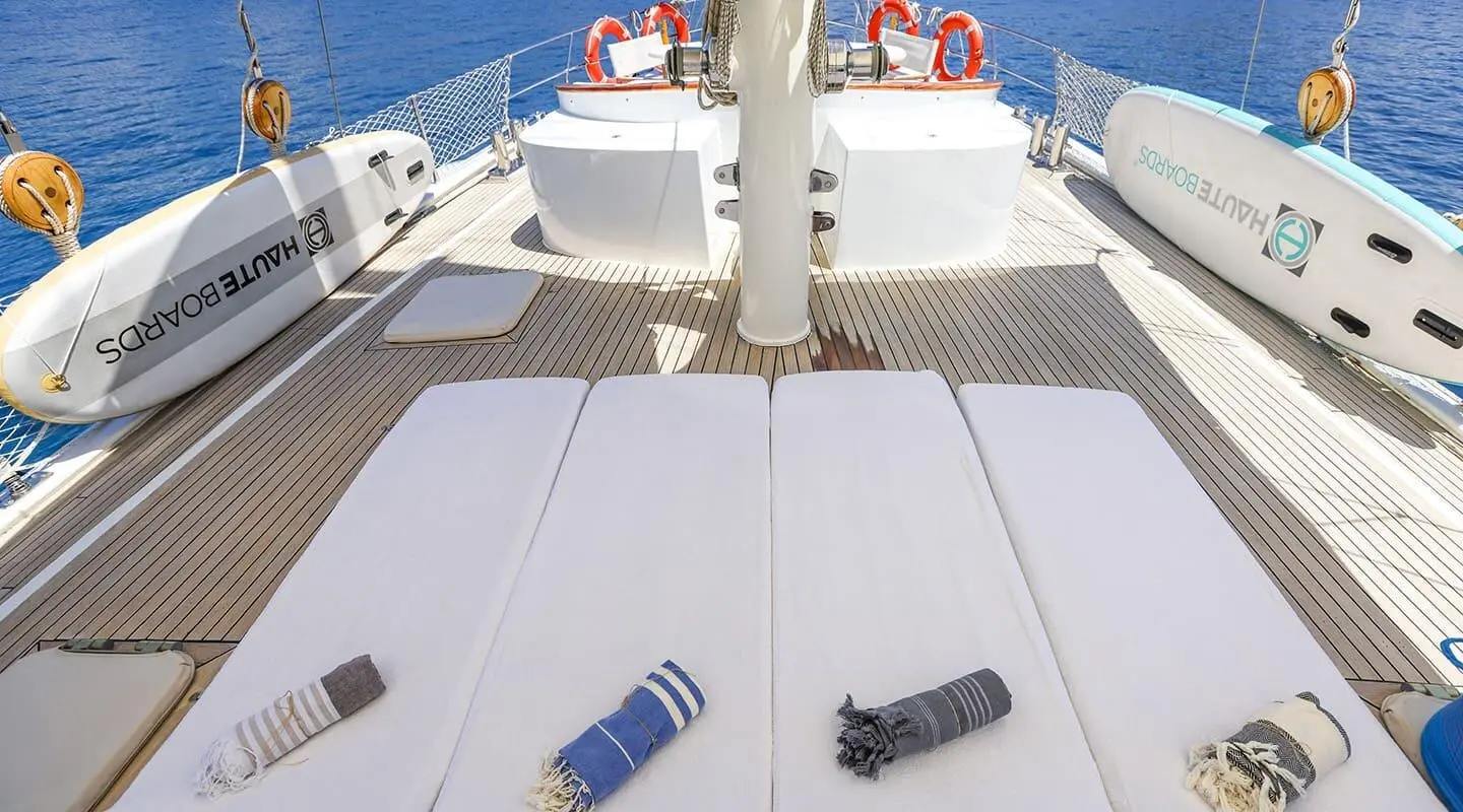 Top deck view of Gazella yacht with ropes, seating, and calm sea horizon