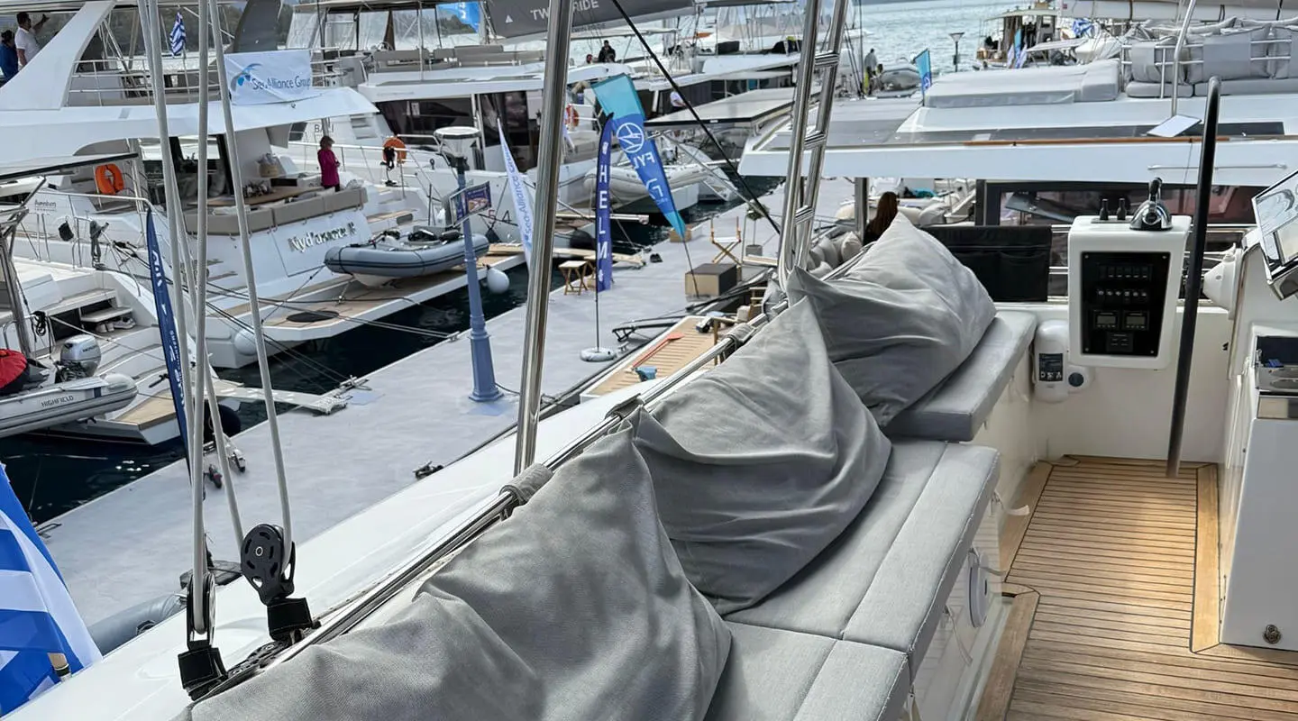 Atlantis luxury yacht deck with grey seating under sails at marina