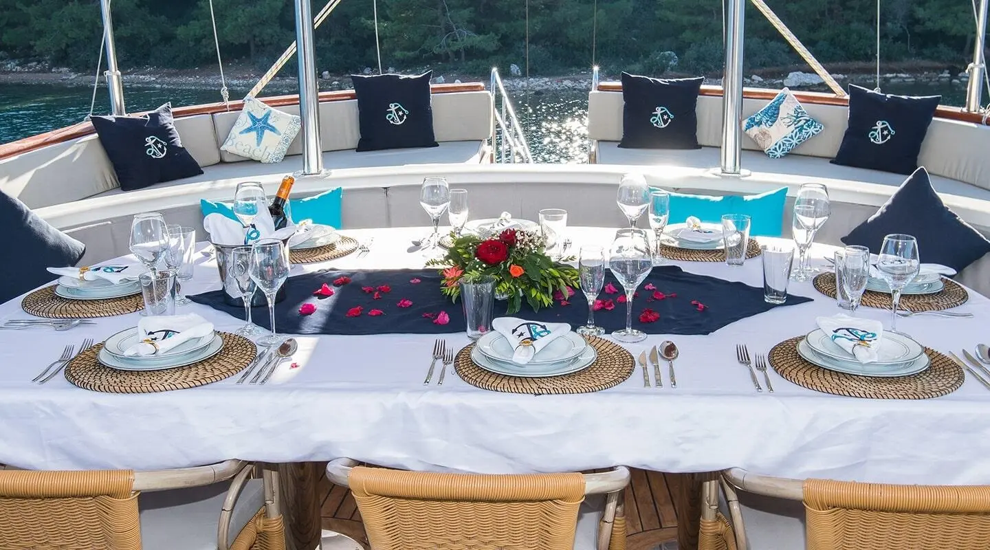 Table set for dining aboard Vista Mare gulet with flowers and place settings
