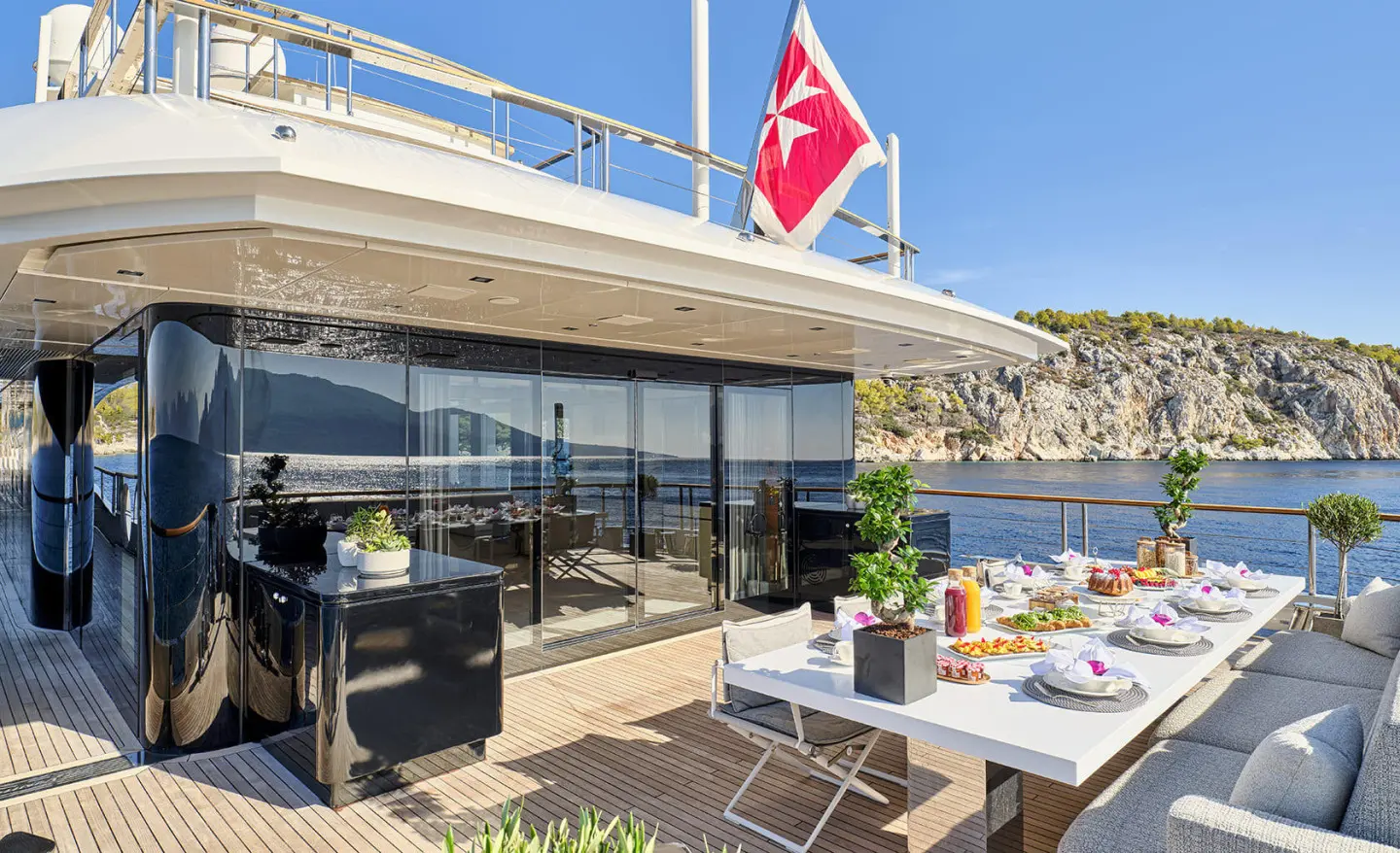 La Pellegrina 1 yacht deck dining area at sunset with tables and chairs