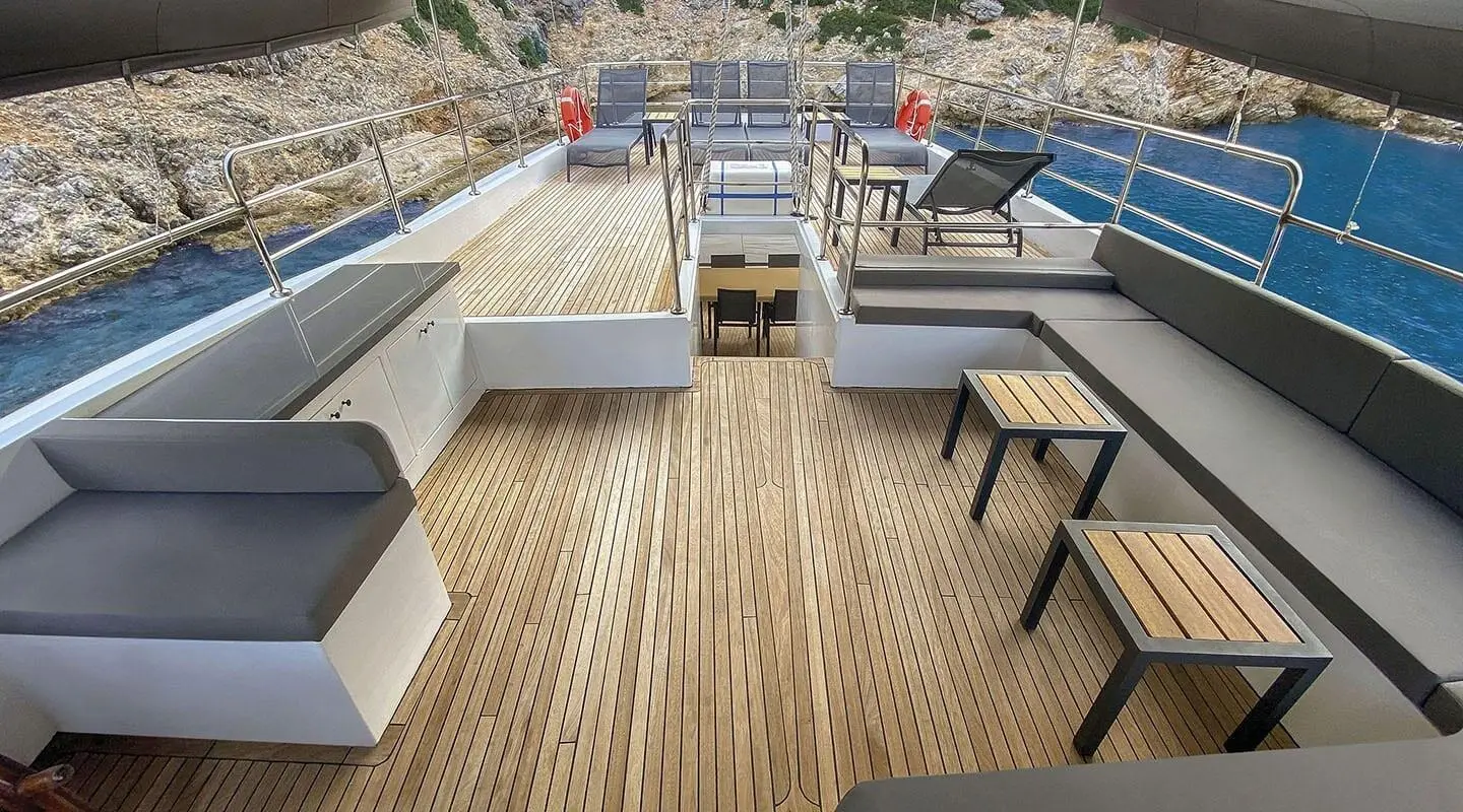 Maske 5 yacht deck with seating, teak floor, and sunset glow