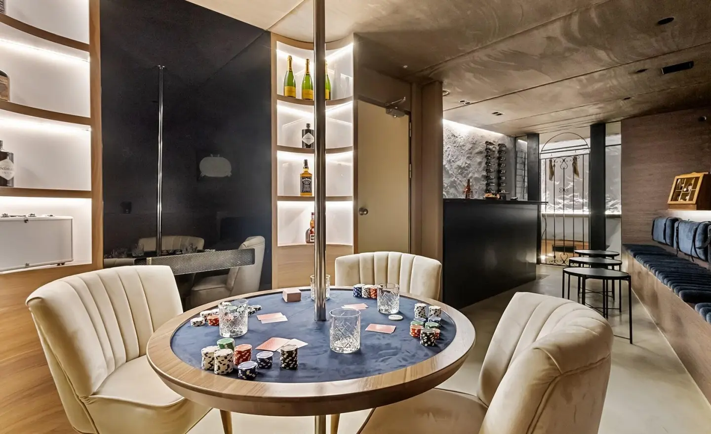 Bella luxury 47.9m yacht poker table in an elegant salon with bottles on shelves