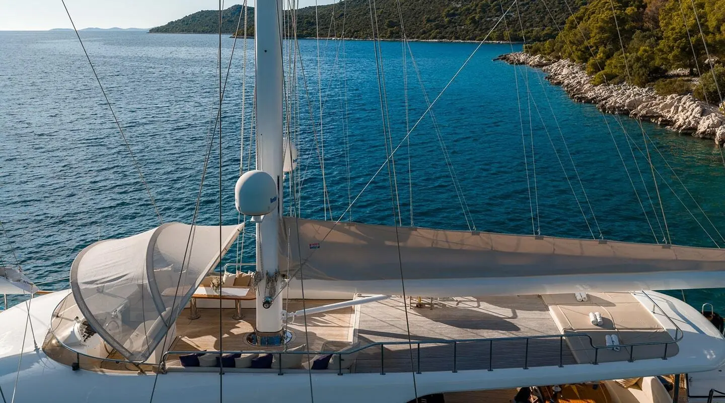 Alessandro I yacht deck at sunset, railing and calm blue sea view
