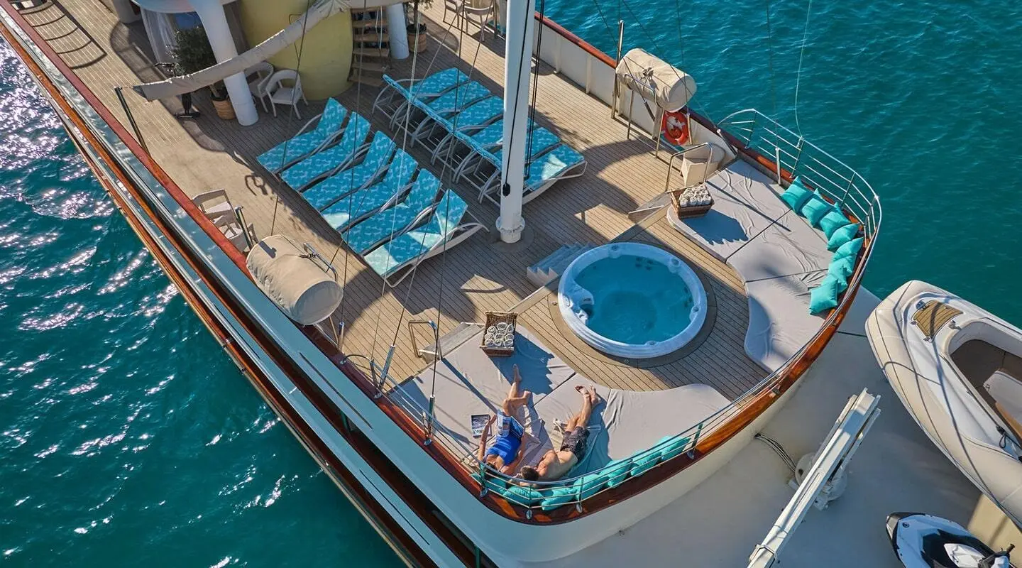 Casablanca motor yacht sun deck with seating and circular hot tub overlooking water