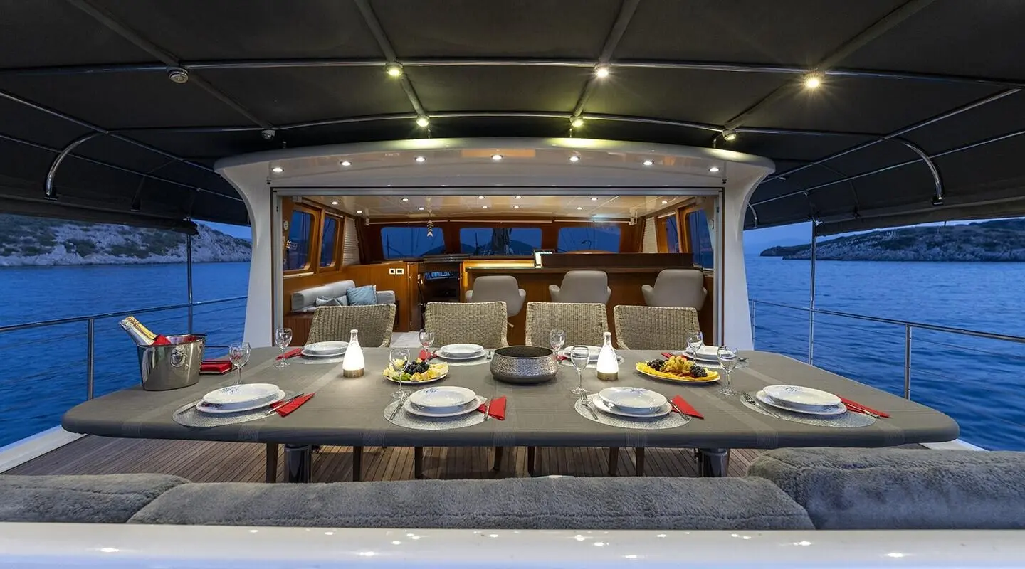 Luxurious yacht Lucky You galley inside with dining setup and sunset view