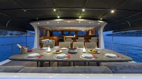 Luxurious yacht Lucky You galley inside with dining setup and sunset view