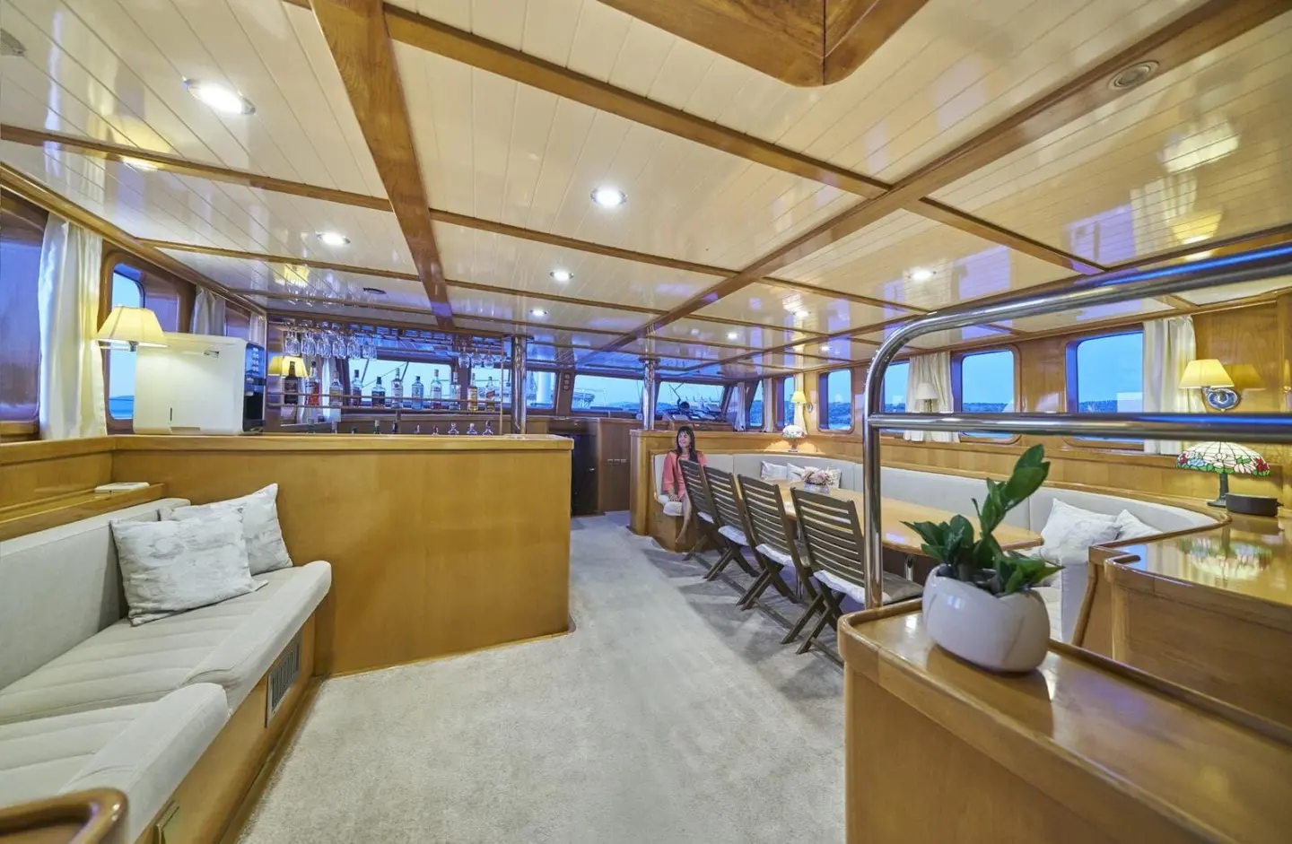 Inside saloon of Morning Star gulet with seating, tables, and blue accent lighting