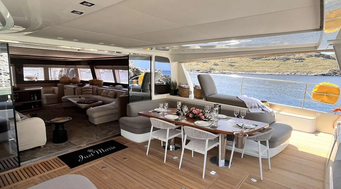 Dining area aboard Just Marie 2, wooden deck seating with tables