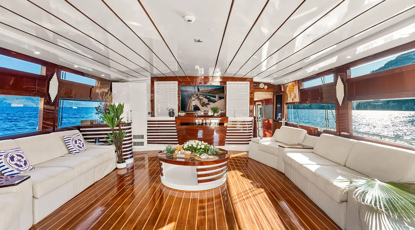 Esma Sultan yacht deck with polished wood, white seating, and open cockpit at sunset