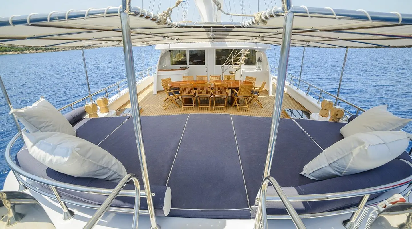 Bella Mare yacht charter on deck with seating and ocean views at sunset