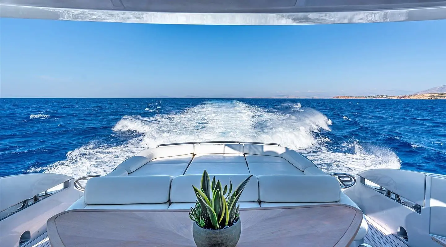View from yacht One charter bow seating overlooking blue sea and wake