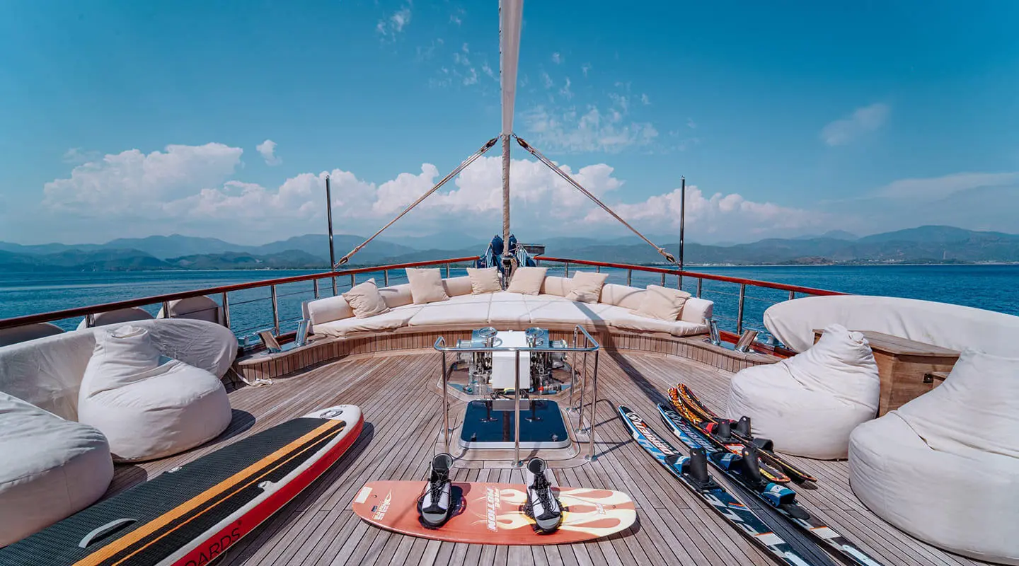 Lycian Queen luxury gulet deck at sunset with sun loungers and sails