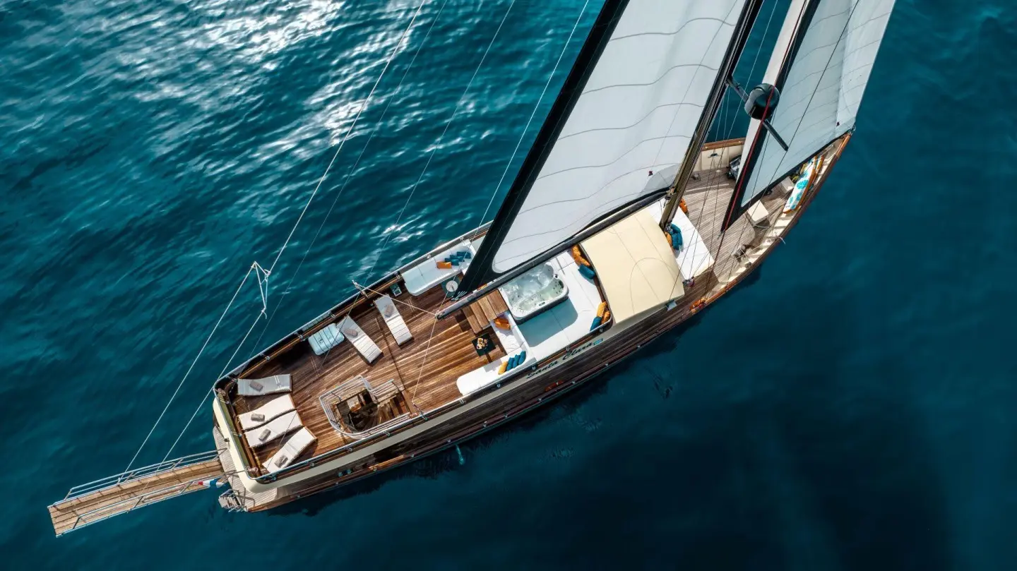 Aerial view of Santa Clara yacht anchored near clear blue water and deck seating