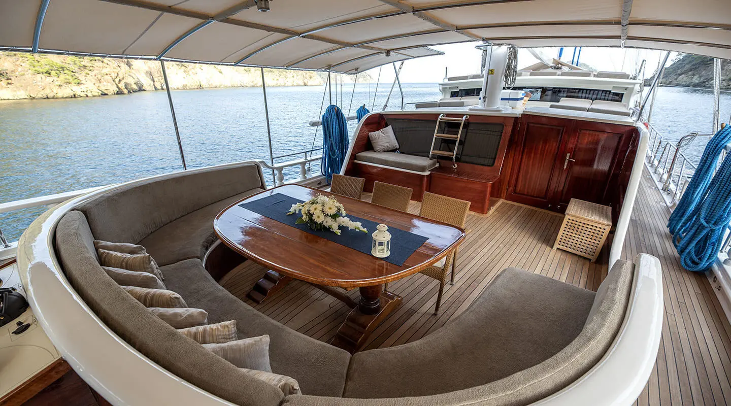 Kayhan 5 yacht charter cockpit aboard at sunset with table and seating