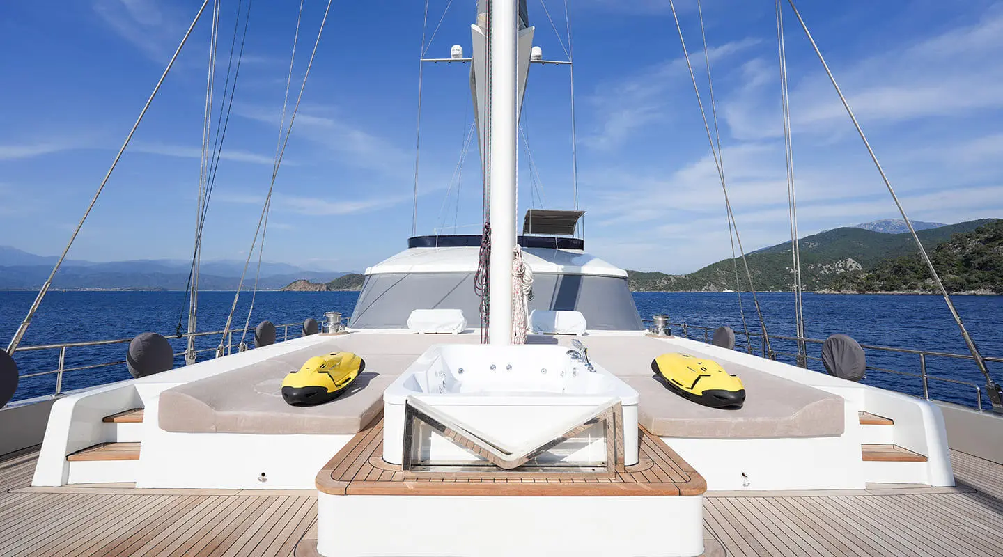 View from bow of King Of The Sea yacht, deck with ropes and yellow fenders
