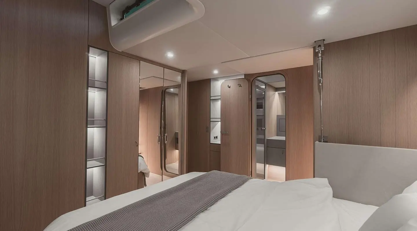 Nadamas yacht interior with wooden cabinets and soft lighting in a double cabin
