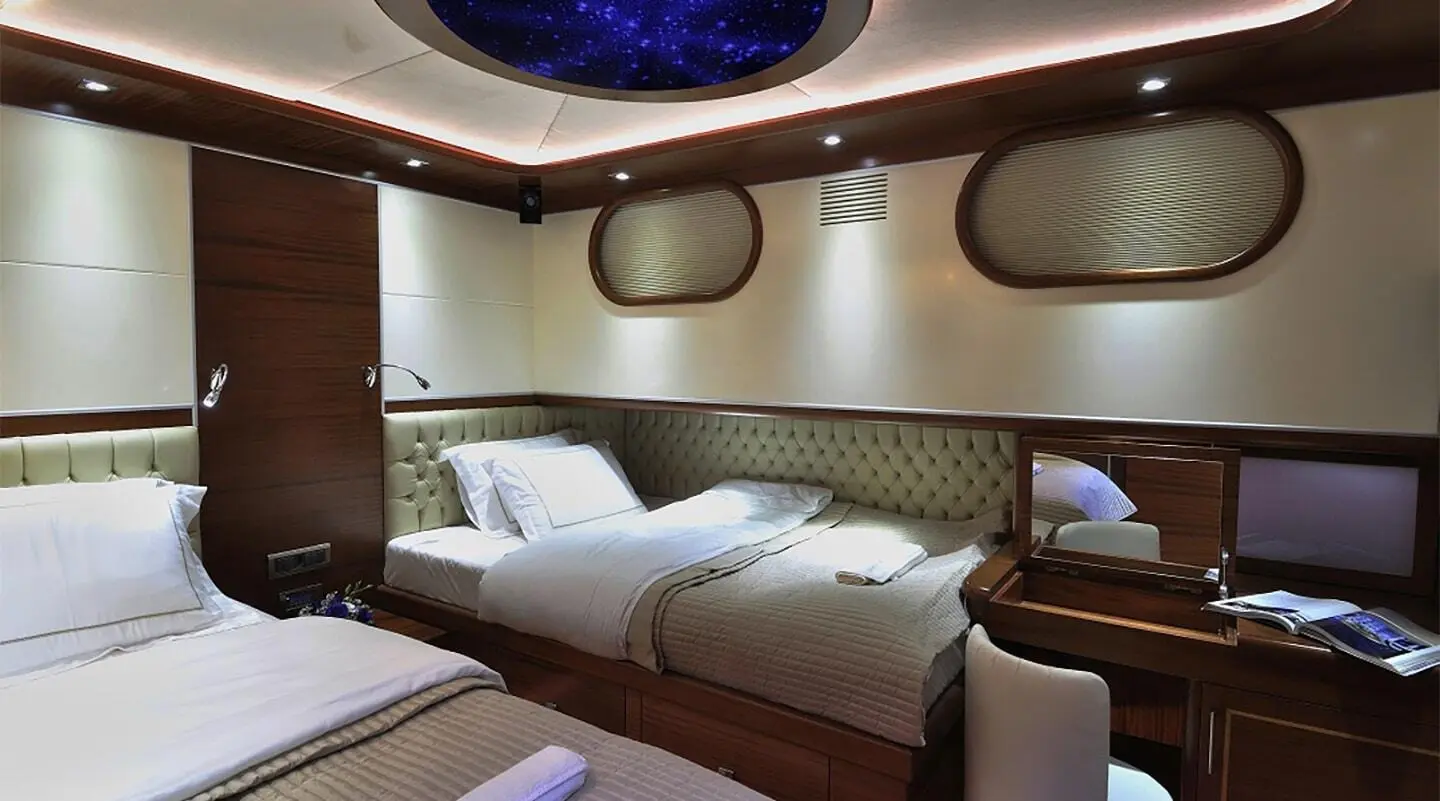 Dolce Mare luxury yacht interior with twin beds and wooden cabin walls
