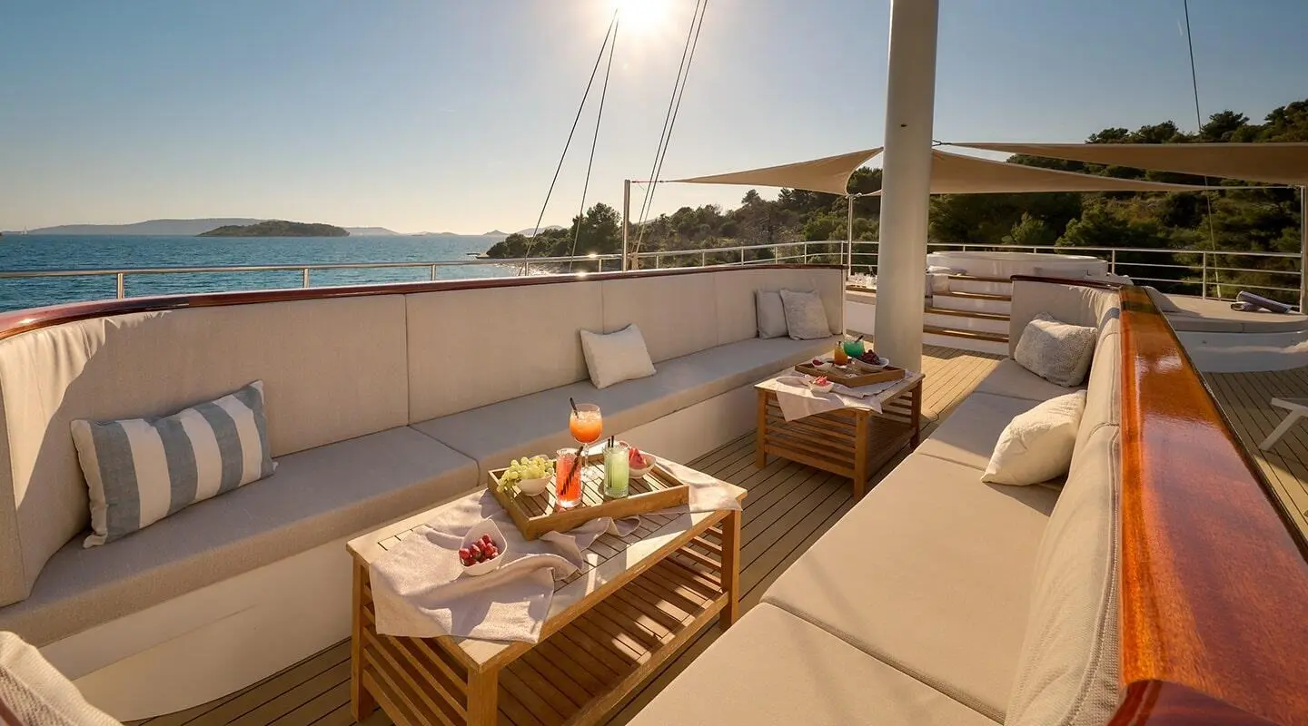 Bellezza yacht sun deck with seating and tables